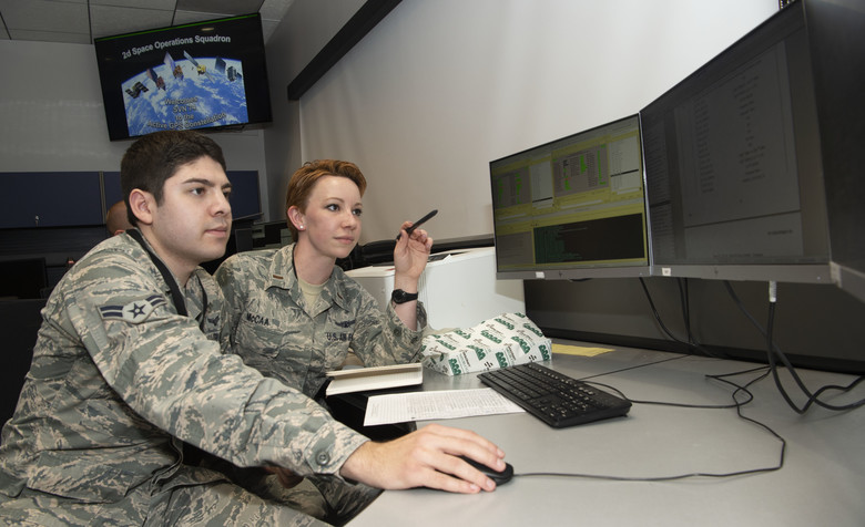 Second Lt. Kelley McCaa, 2nd Space Operations Squadron satellite vehicle operator, and Airman 1st Class John Garcia, 2nd SOPS satellite systems operator, set satellite vehicle number-74, the first iteration of GPS Block III vehicles, as healthy and active to users Jan. 13, 2020, Schriever Air Force Base, Colorado,. Setting the vehicle healthy and active makes the satellite available for use by military and civilian GPS users around the world for agriculture, banking and navigation. (Photo: U.S. Air Force/Staff Sgt. Matthew Coleman-Foster)