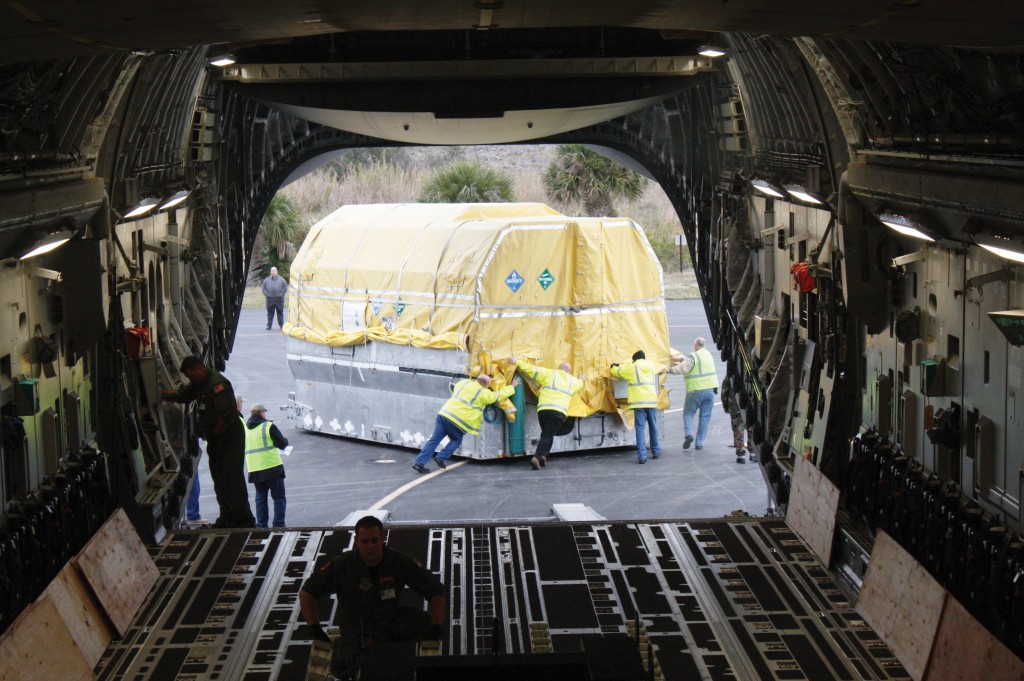 It takes four hefty guys to wheel the new satellite along the tarmac, but it will only take one Delta IV rocket to lift it 20,171 kilometers into space on May 13.