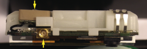 Figure 6. Edge view of GPS antenna, top of phone removed. This phone includes an external GPS antenna input connector seen here mounted below the patch antenna. (Image: Tony Haddrell, Marino Phocas, and Nico Ricquier)