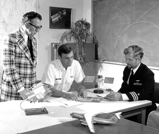 At the JPO. Frank Butterfield of Aerospace, Col. Parkinson, and Cdr. Bill Huston, deputy JPO director from the U.S. Navy, in the early 1970s. A model of a Phase I GPS satellite stands on the table between the latter two. (Credit: Bradford W. Parkinson and Stephen T. Powers)