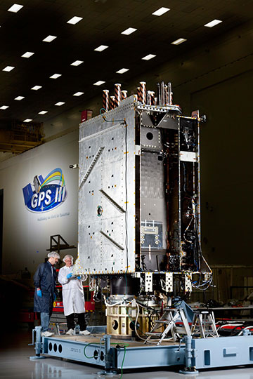 Lockheed Martin engineers work on the full-sized prototype of the GPS III satellite in the company’s GPS Processing Facility (GPF) near Denver.