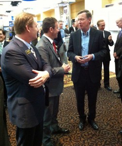 Colorado Gov. John Hickenlooper discusses space matters at the 30th Annual Space Symposium with Braxton Chairman of the Board Kevin O'Neil and Braxton CEO Frank Backes.