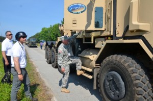 Colonel Bruce B. McPeak, Director of Materiel Systems, Combined Arms Support Command, climbs into a Heavy Equipment Transporter (HET) for an autonomous ride-along.