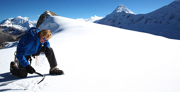 John All takes an ice sample from a glacier in the Ishinca Valley, Peru.
