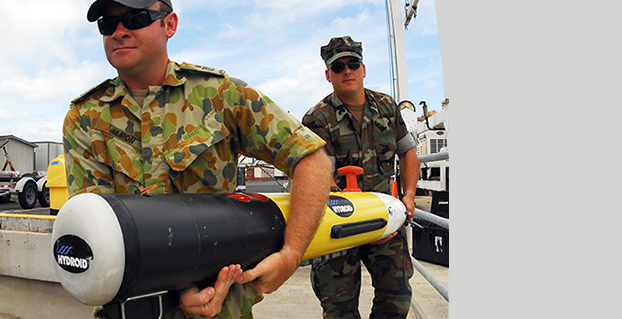 Sailors carry a Remote Environmental Measuring Unit (REMUS) 100. (Credit: U.S. Navy)