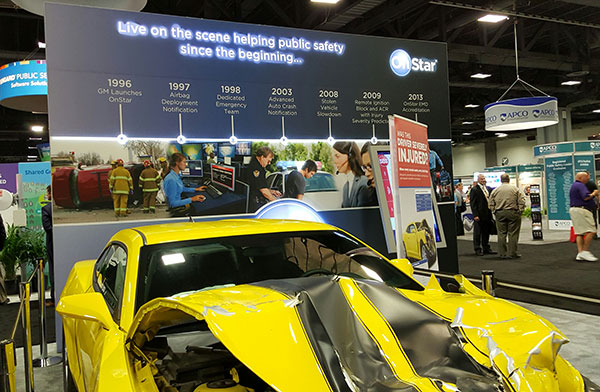 OnStar booth features wrecked car to portray emergency messaging capabilities at APCO.