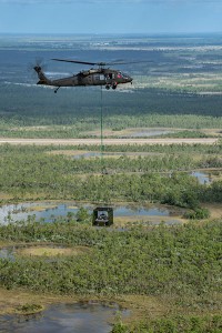 An unmanned Black Hawk delivers an autonomous ground vehicle to a remote site in a demonstration for the U.S. Army of a joint robotic air-ground mission.