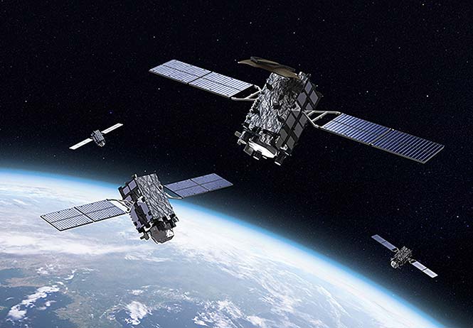 FIGURE 1. An artist’s view of the QZSS satellites. The upper-most satellite is the geostationary QZS-3 spacecraft with the additional S-band dish antenna whereas the other satellites pictured are the inclined geosynchronous satellites. (Image: Mitsubishi Electric/JAXA)