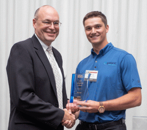 Defense takes center stage at Leadership Awards. John Raquet, AFIT, accepts 2018 Leadership Award for Services from Justin Eldredge, Spirent Federal. (Melanie Beus photo)