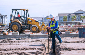 A surveyor checks an urban construction project. (Photo: Topcon)