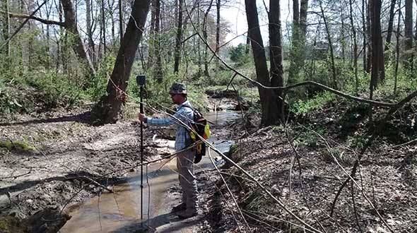 In Cleveland County, North Carolina, surveyor Adam Plumley determines exactly where a creek crosses a property line. (Photo: AP Surveying PLLC)