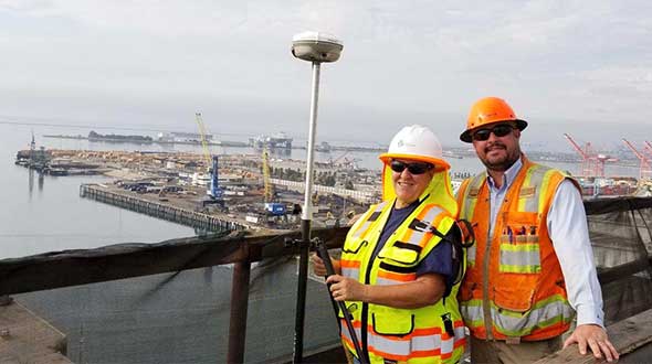 In Long Beach, California, correction services support the 250-foot-high Gerald Desmond Bridge project. Trevor Rice (left), president of D. Woolley & Associates, joins Kimberley Holtz, director of survey, Port of Long Beach. (Photo: Trimble)