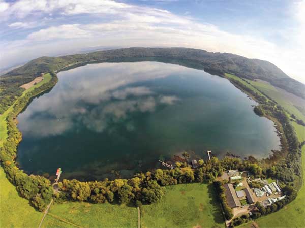 An aerial view of Laacher See, a volcanic caldera lake with a diameter of 2 km in Rhineland-Palatinate, Germany. Created by volcanic activity, maars like this are also found in other parts of Europe and on other continents, but Eifel-Maars are the classic example worldwide. (Photo: bbsferrari/iStock / Getty Images Plus/Getty Images)