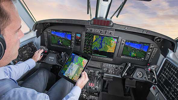 In a simulated G1000 NXi integrated flight deck for a King Air 350, a pilot refers to the Garmin Pilot app, used as a supplement during flight. (Photo: Garmin)