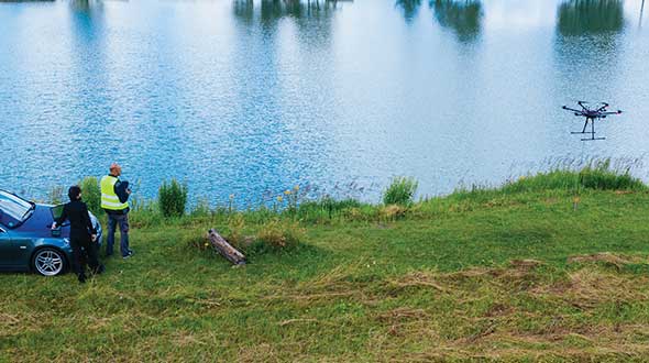 A UAV from SPH Engineering tows a bathymetric sonar just under the surface of a river. (Photo: SPH Engineering)