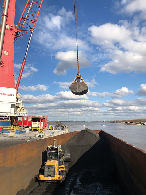 A remotely controlled front loader operates inside a barge. (Photo: Caterpillar)