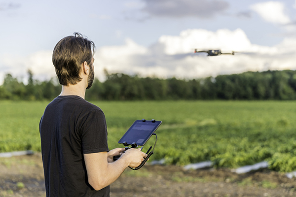 A Canadian drone pilot flies a UAV over a field. (Photo: Onfokus/iStock/Getty Images Plus/Getty Images)