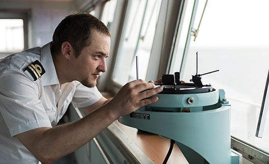 A deck officer on a ship takes a relative bearing using a pelorus. Loran-C was developed in large part for maritime navigation. (Photo: aytugaskin/iStock/Getty Images Plus/Getty Images)