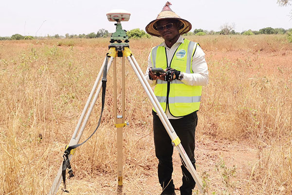 A surveyor in Burkina-Faso surveys the site of a new hospital for infectious diseases. (Photo: ComNav)