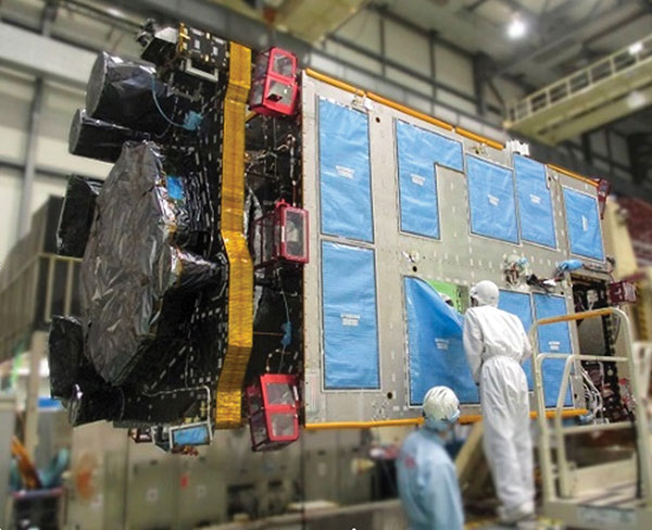 QZS-R1 is prepped for testing. At left is the Earth-oriented surface that hosts the L-band antenna. (Photo: JAXA)
