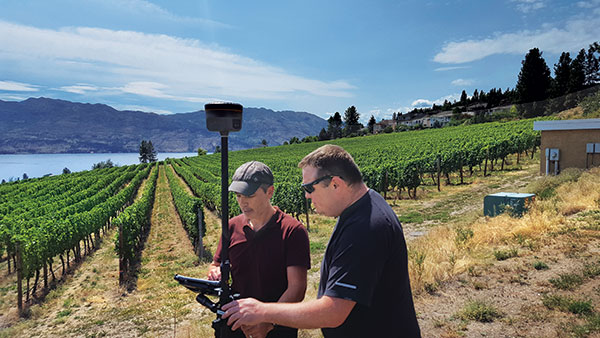 jason poitras (left) and MARC VEINOTTE of MicroSurvey test a multi-constellation OEM rover with the FieldGenius for Android field controller software. (Photo: Gavin Schrock)
