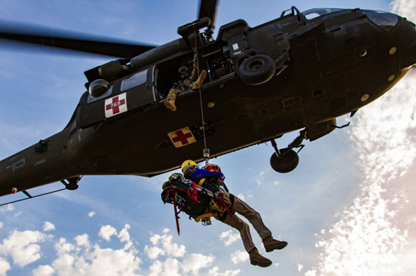 A U.S. Army HH-60 Black Hawk helicopter lowers a volunteer from Central Washington Mountain Rescue via the hoist system during a training exercise.(Photo: U.S. Army)