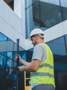 A surveyor using an Emlid mobile RTK network rover, a Reach RX, in an urban environment. (Photo: Emlid)