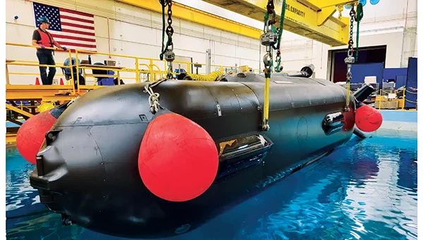 An Orca extra large UUV (XLUUV) is tested in a tank. With a range of 6,500 nautical miles, the submarine can perform long missions. Its navigation system features a Kalman-filtered inertial unit supported by Doppler velocity logs and depth sensors. Photo: Boeing