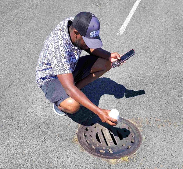 The compact ComNav Technology Venus rover has tilt compensation and a ranging/tracking laser that can be used to do measure-ups when on a pole or offset point/stakeout as shown in this example of measuring a drainage hole invert. (Photo: Gavin Schrock)