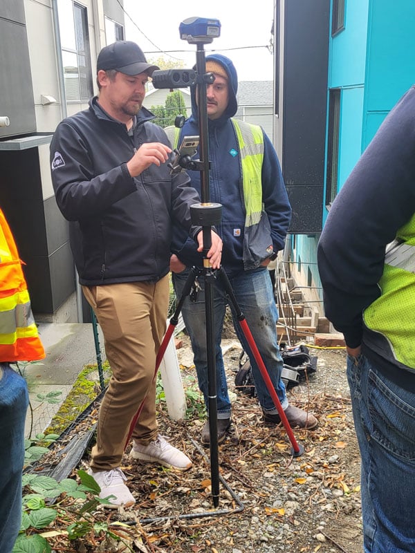 Adding peripherals is another approach for multi-sensor rovers. This system enables sky-view challenge data collection, as in this location between two buildings, with an angle encoder (middle of the pole) and offset rangefinder (under the Eos Skadi rover). With this combination, users can perform the equivalent of closed traverse loops. (Photo: Eric Gakstatter)