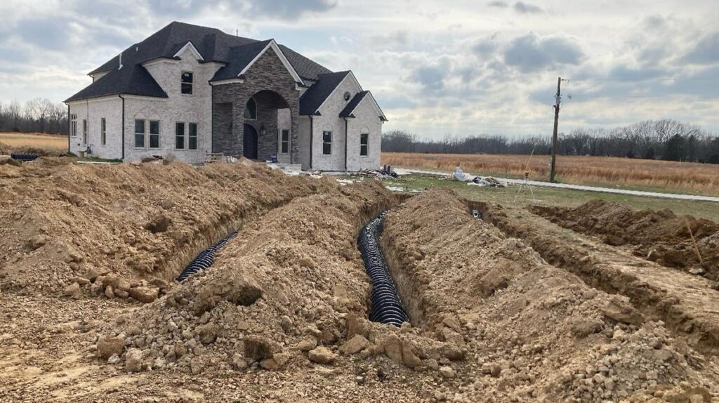 Inspectors assess whether a new septic drain field meets state regulations before the property can be occupied. 