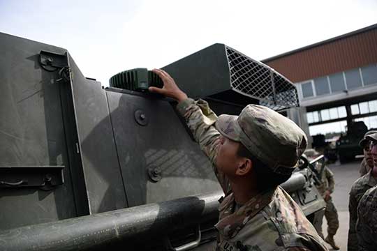 A soldier checks part of a Mounted Assured Precision Navigation & Timing System -- known as MAPS. Sixty-two of the first iteration of mounted anti-jam GPS devices were equipped into light armored vehicles in Germany over the past month, with thousands more scheduled to be installed into U.S. European Command vehicles by 2028. (Photo: John Higgins)